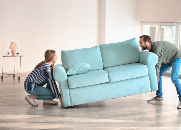 Couple moving sofa | Tri-City Carpet